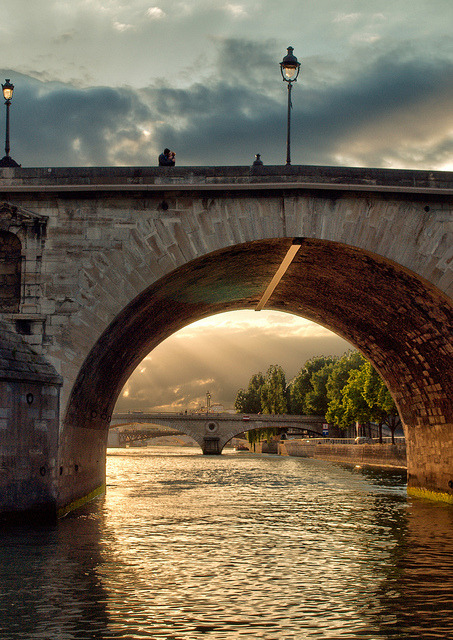 A kiss on a bridge over the River Seine, Paris, France