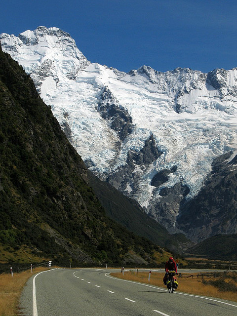 Cyclist on the road to Mount Cook in South Island, New Zealand