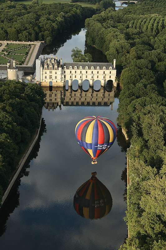 Chenonceau Castle and a ballon reflected on the Cher river, France